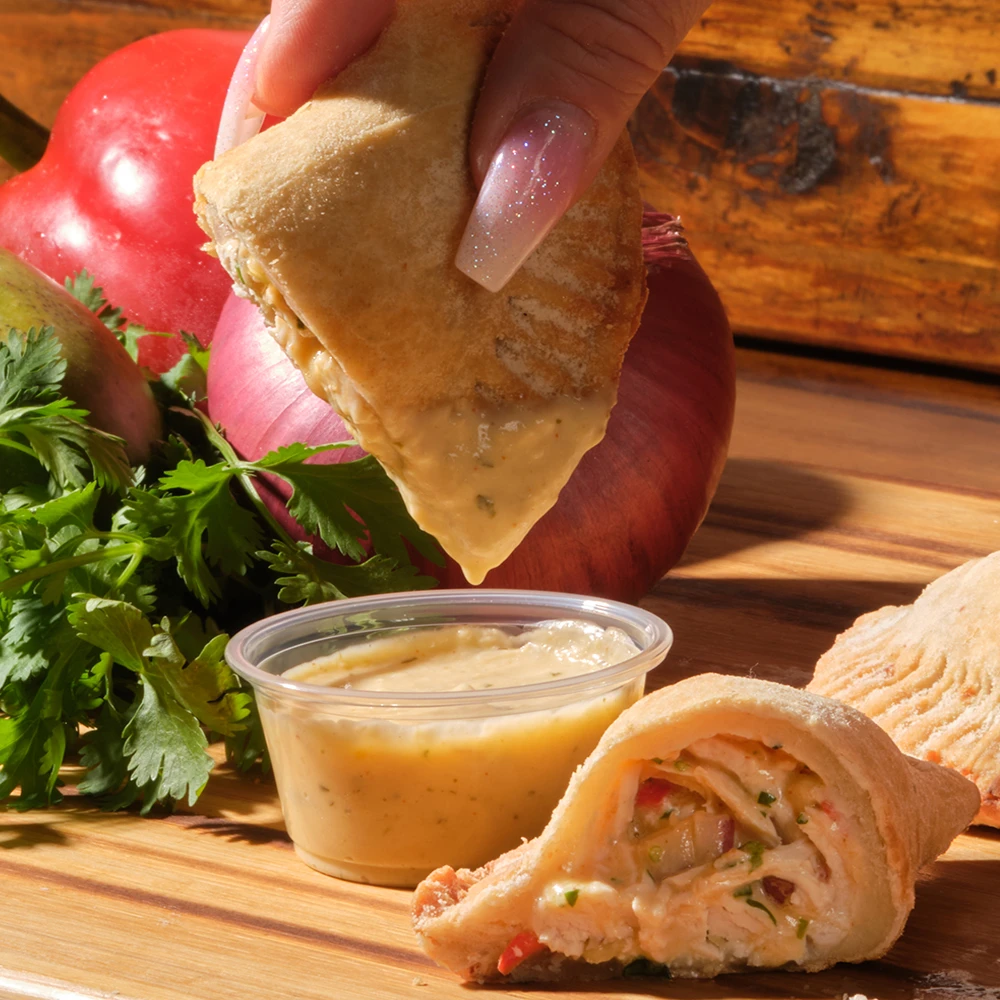 Passion Chicken empanada with mango and passion fruit sauce