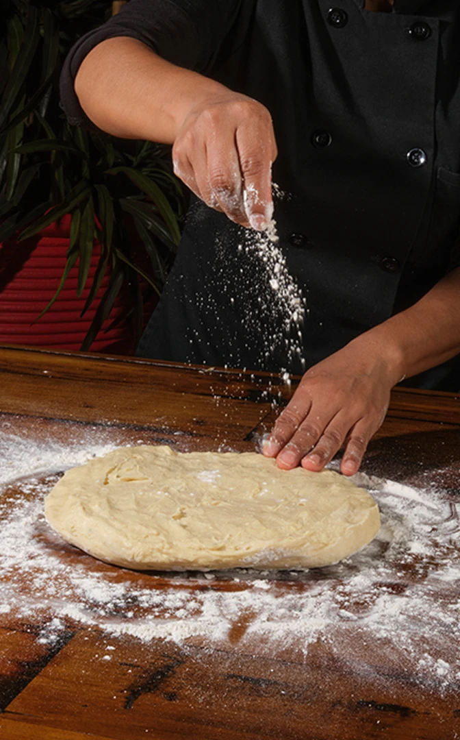Dough being rolled and filled by hand in the Loaded Empanadas kitchen