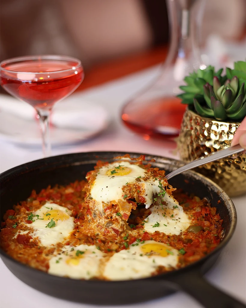 Havanas Eggs: Cuban-style eggs simmered with tomatoes, peppers and onions