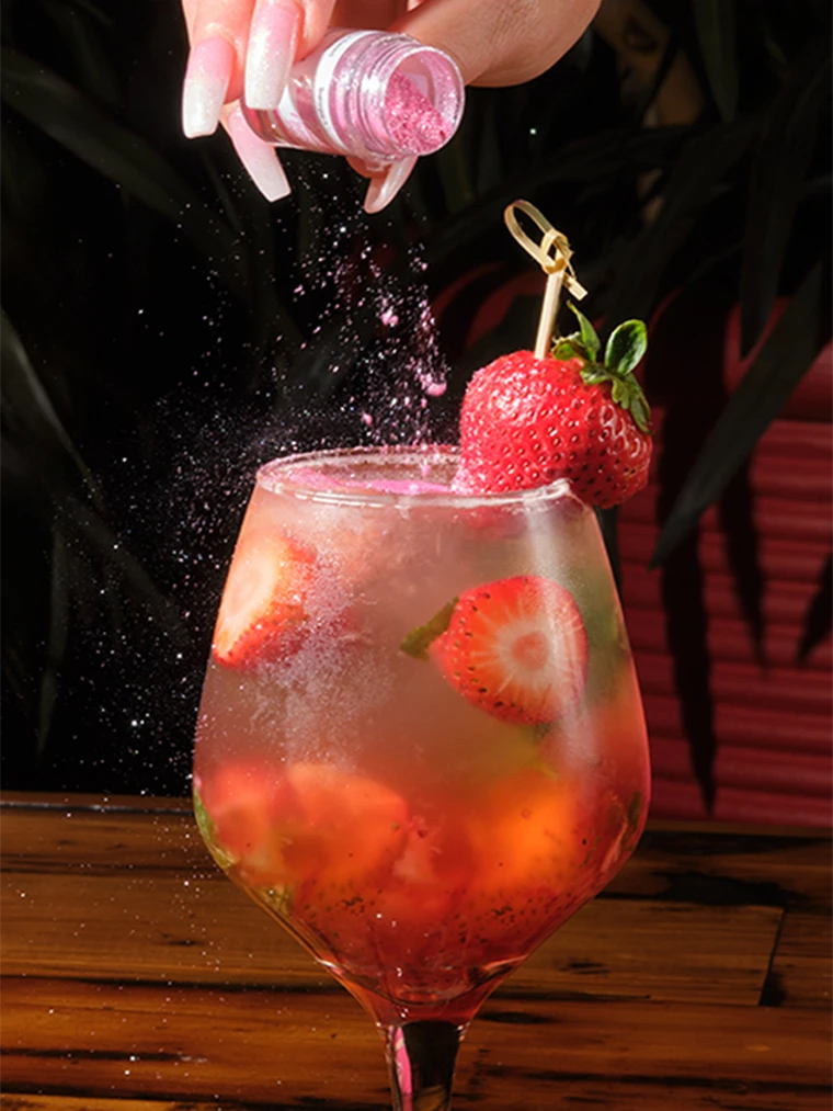 Strawberry sangria in a stemmed glass, finished with shimmer dust