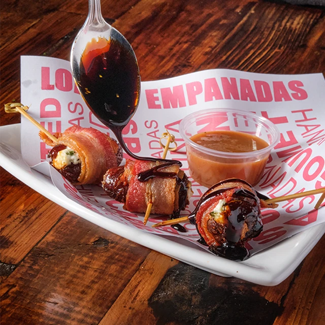 Dates wrapped in bacon with balsamic drizzle and dipping sauce